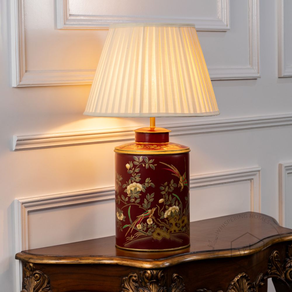 Gilded Phoenix Red Metal Table Lamp with Off White Pleated Lamp shade Light On White Background