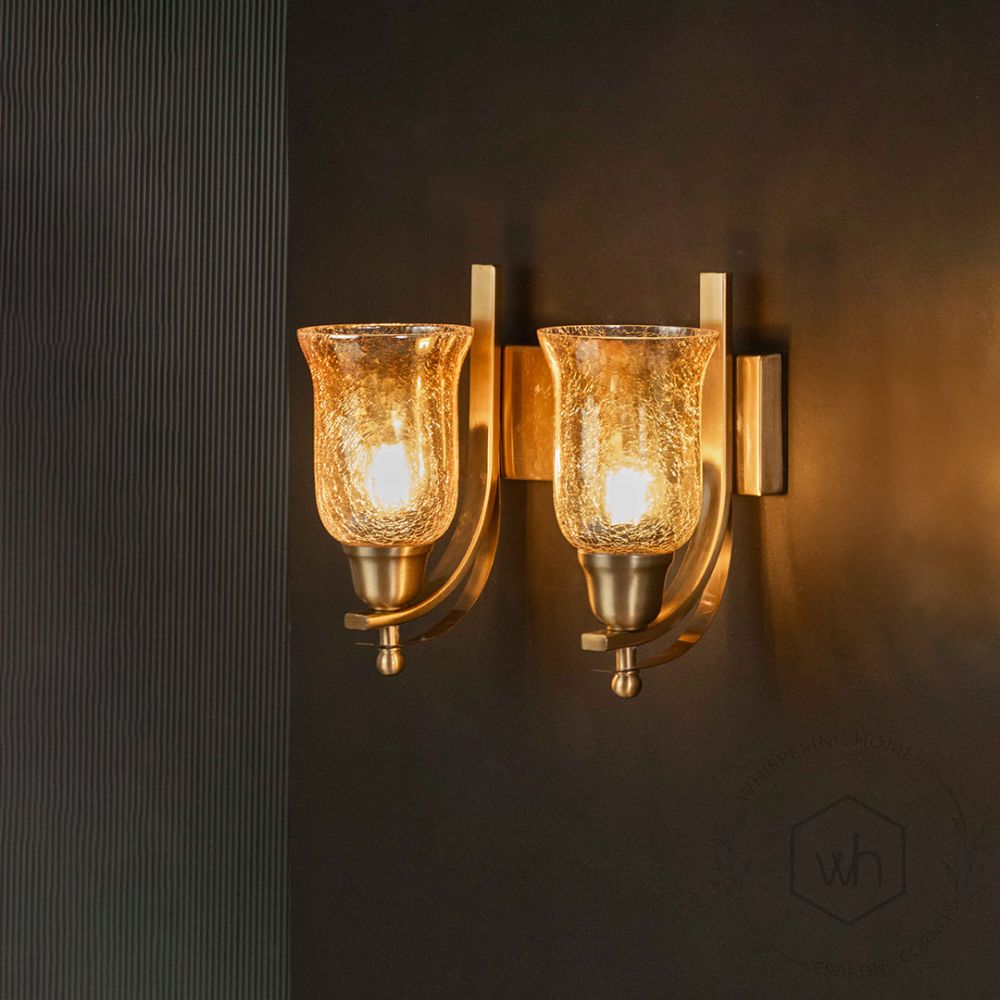 Crown Jewel Brass Double Sconce light on black background