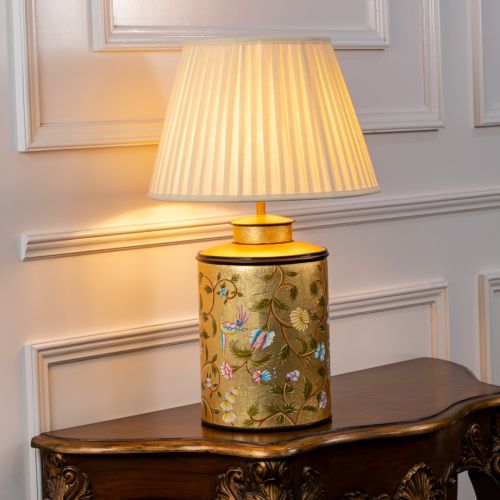 Oriental Orchard Gold Metal Table Lamp with Off White Pleated Lamp shade Light On White Background