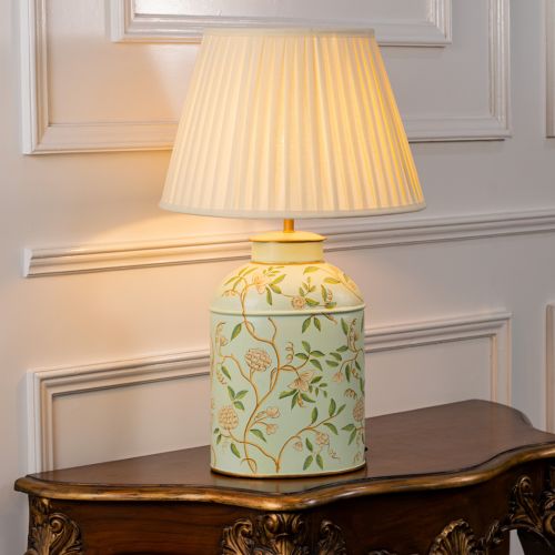 Tropical Garden White Metal Table Lamp with Off White Pleated Lamp shade Light On White Background